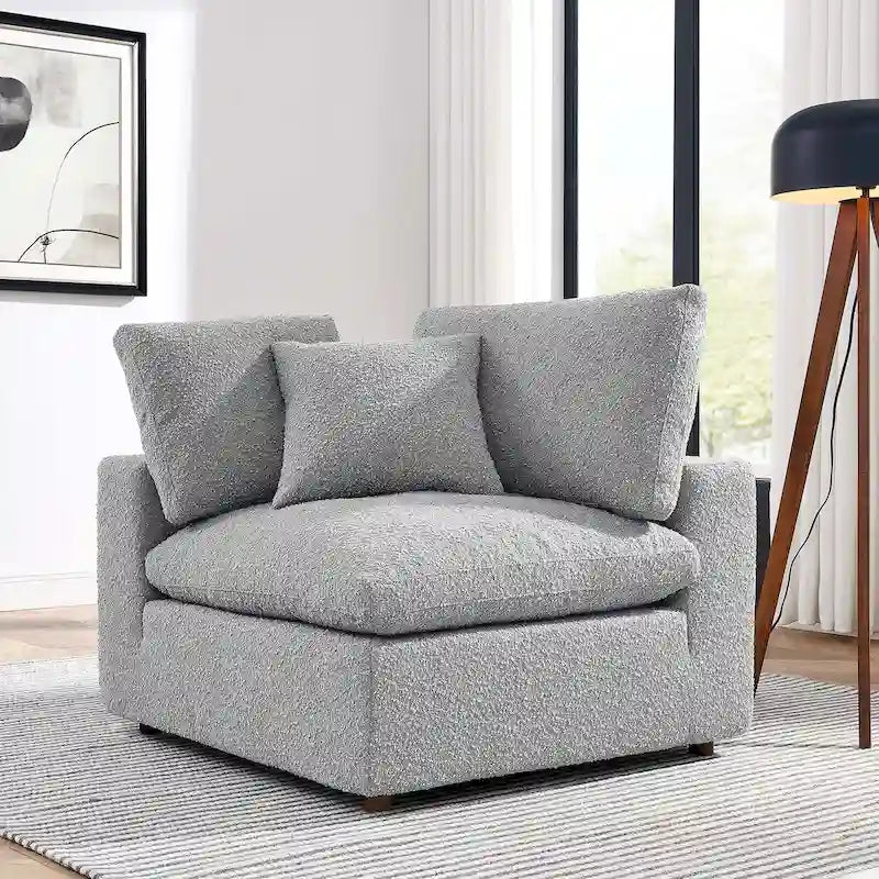Fauteuil d'angle rembourré en tissu bouclé garni de duvet