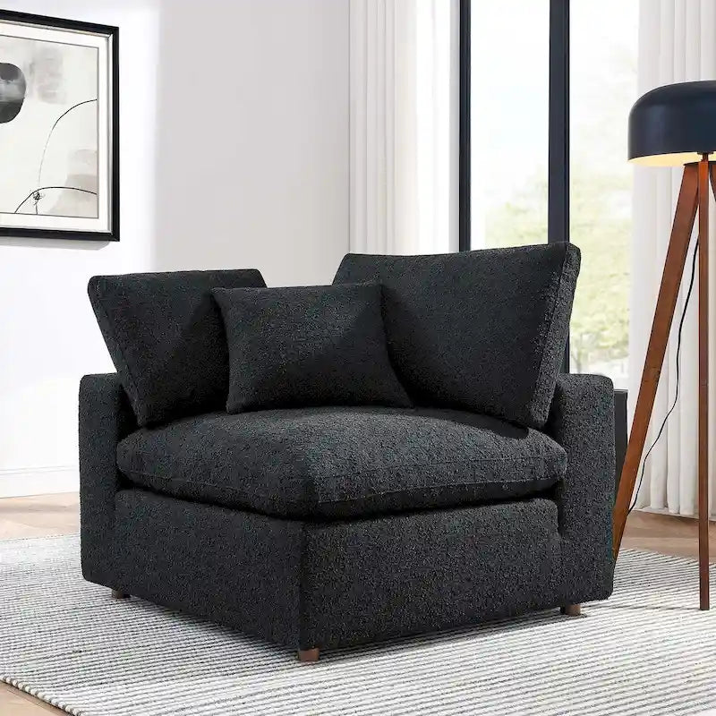 Fauteuil d'angle rembourré en tissu bouclé garni de duvet